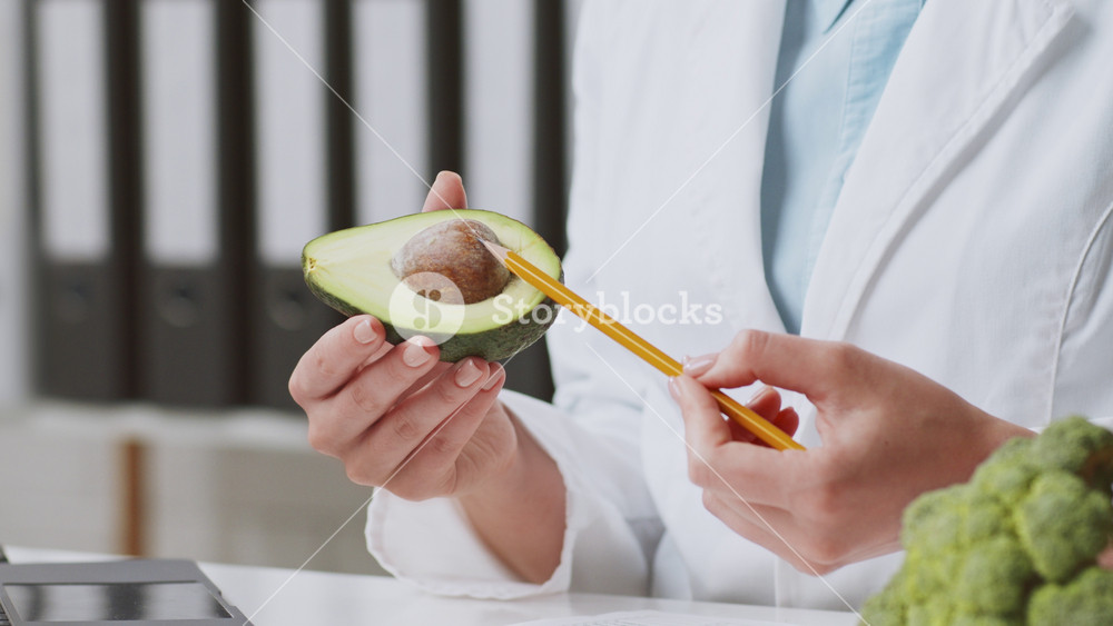 A wearing a lab coat and reviews dietary plans in a well-organized clinic. The calm atmosphere promotes focus on patient health and