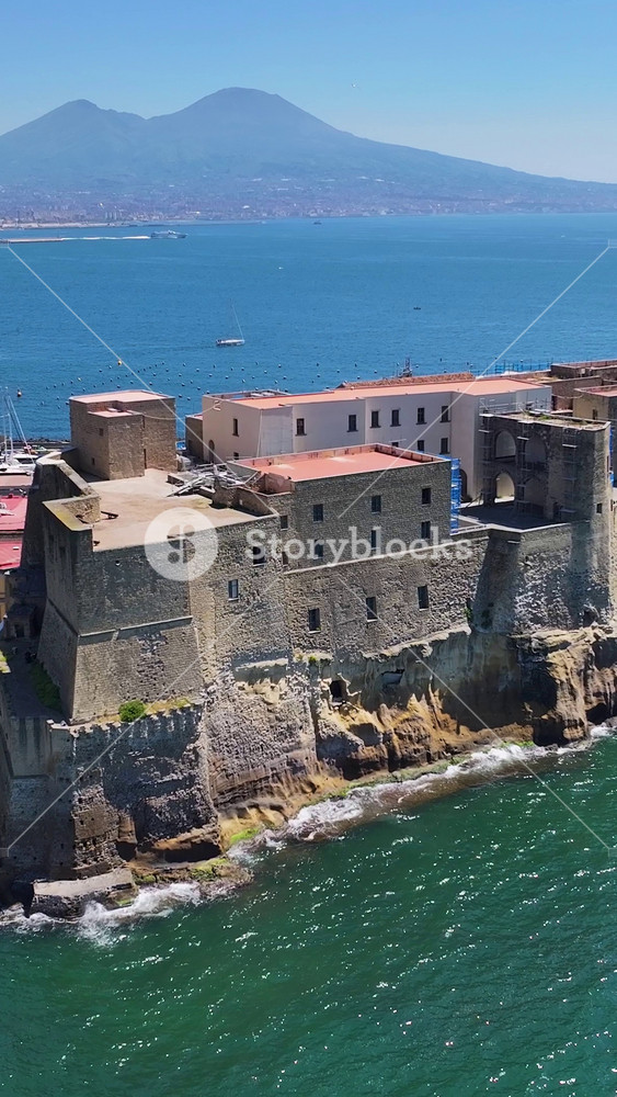 Dell Ovo Castle In Naples Campania Italy. Birds Eye View Of Medieval Building In Famous District Of City. Coast Clouds Seaside Summertime. Coast Outdoor Tropical Environment. Naples Campania.
