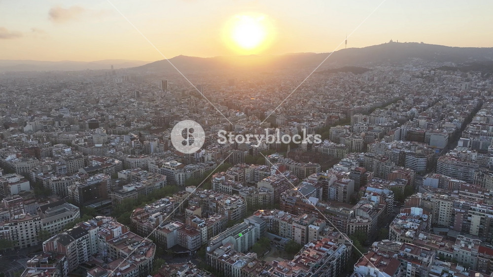 Sunset Over City At Barcelona In Catalonia Spain. Sunset Cityscape. Downtown District. Tourism Landmark. Sunset Over City At Barcelona Spain. Highrise Buildings Skyline. Spain Skyline.