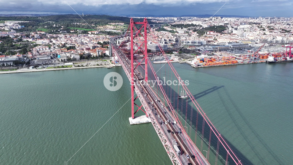 25 Of April Bridge At Lisbon In Lisbon District Portugal. Downtown City Skyline. Transportation Scenery. 25 Of April Bridge At Lisbon In Lisbon District Portugal. Famous Cable Stayed Bridge.