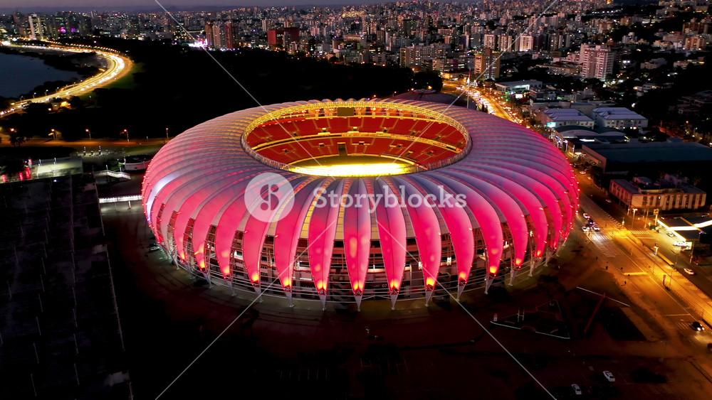 Porto Alegre, Rio Grande Do Sul, Brazil - 5.26.2025 - Beira Rio Stadium At Porto Alegre In Rio Grande Do Sul Brazil. Night Skyline. Modern Football Stadium Overlooking A Dense Downtown City.