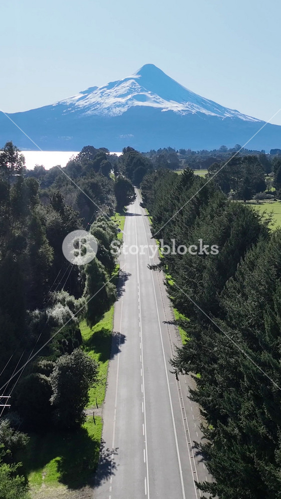 Patagonia Road In Puerto Octay Los Lagos Chile. Breathtaking Aerial View Of Busy Traffic In A Freeway Road. Nature Tourism Icon Snow Covered Forest Trees. Snow Covered Patagonia Above View.