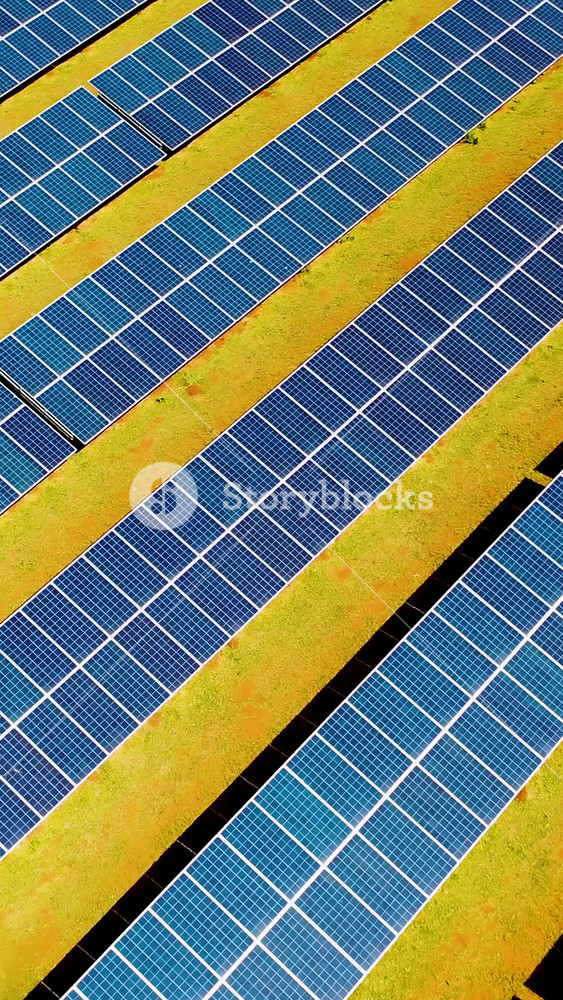 Photovoltaic solar panels farm. Green energy generation. Solar panels field at countryside. Cleaning energy for control of climate change. Environment emissions reduction.
