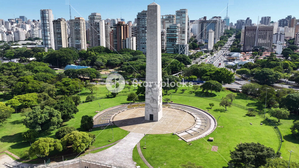 Obelisk Monument In Sao Paulo Brazil. Highrise Buildings. Nature Park. Ibirapuera Park Cityscape. Obelisk Monument In Sao Paulo Brazil. Cultural Heritage Landmark.