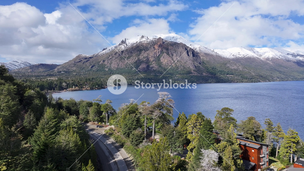 Patagonia Road In San Carlos De Bariloche Patagonia Argentina. Urban Life Landscape Of Freeway Road Connecting City Streets. Nature Tourism Icon Snow Covered Forest Trees.