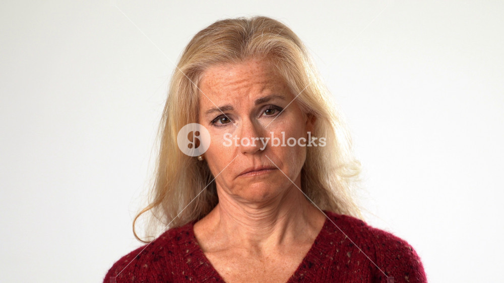Closeup portrait of tired upset middle aged woman suffering from neck pain. Exhausted unhappy elderly mature lady massaging muscles, feeling unwell at home, osteoarthritis ache concept.