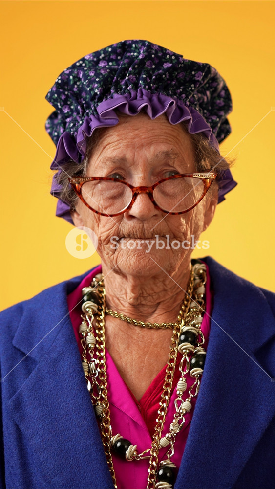 Vertical video of angry, scared elderly senior old funny crazy woman with wrinkled skin and grey hair put hands out ask WHY ME, isolated on yellow background studio. People emotions