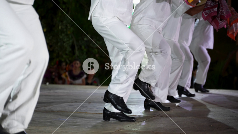 Closeup of men and women dancing a Mexican cultural folk dance sharing the different ethnic dances of the Yucatan in Merida in slow motion.
