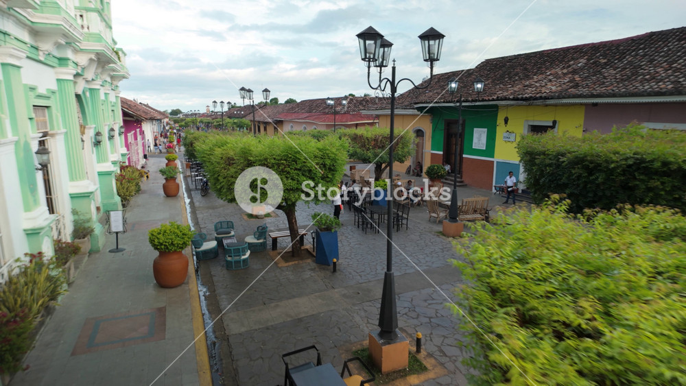 Visit the colonial streets of Granada Nicaragua where people walk and enjoy the vibrant colors and architecture in the town