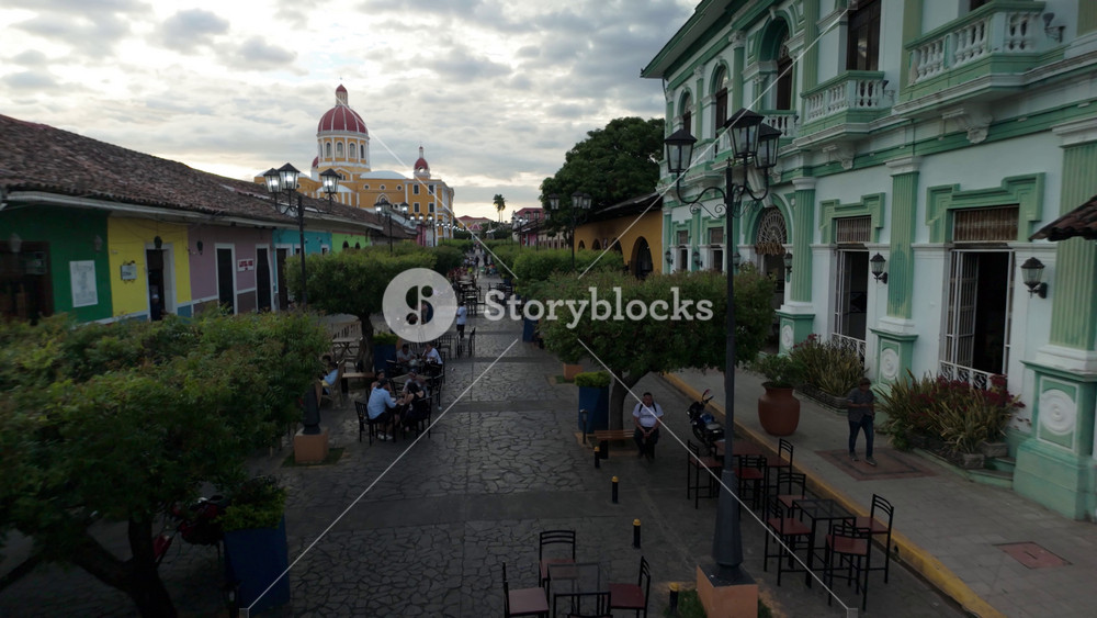 Walk through the colorful streets of Granada Nicaragua. Enjoy views of colonial buildings, cafes, and vibrant outdoor environments