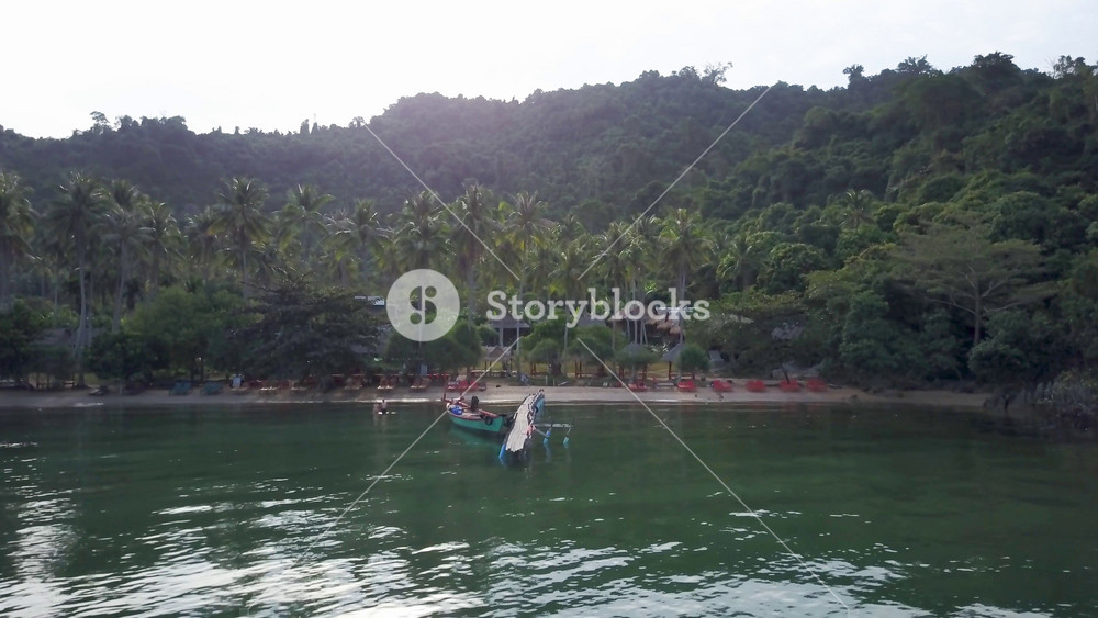 Moving forward, the camera pitches, or turns up to reveal the island paradise of Koh Tonsay, Rabbit Island, Cambodia in the Kep Province.