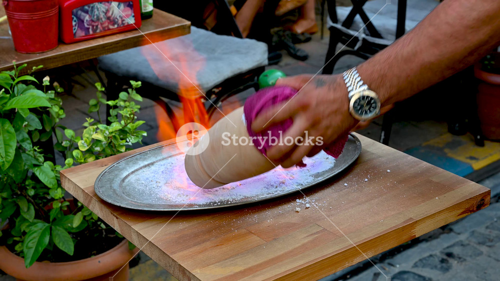 Istanbul,Turkey,August 1,2025. Fascinating video showing the preparation of testi kebab before being served.With deft movements, the hand rotates the terracotta pot over the flame to heat its contents