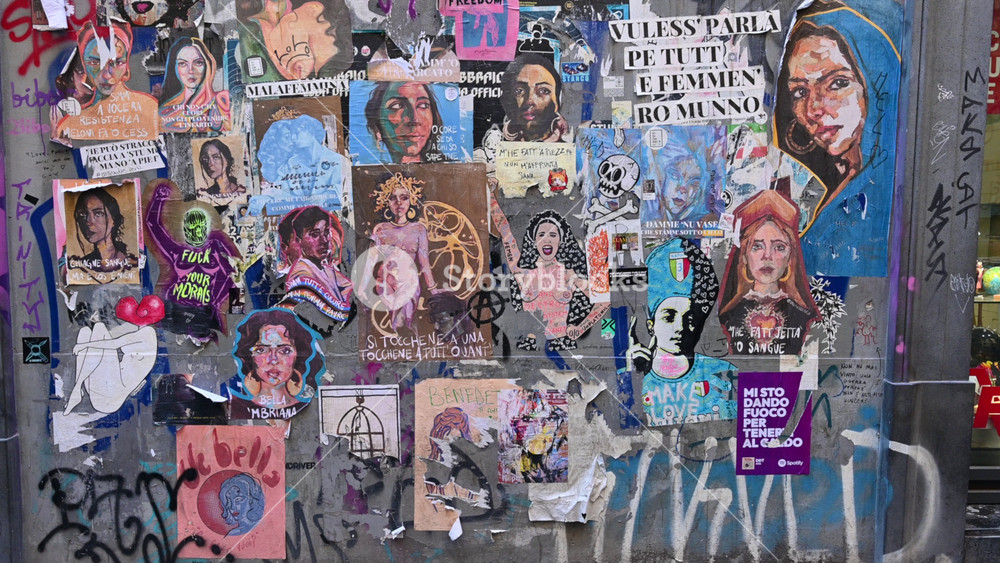 Naples, Italy, December 27, 2024. A wall in the historic center filled with small drawings of female figures and Neapolitan slogans.