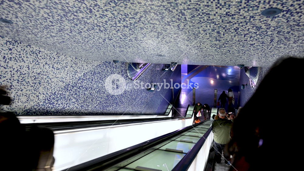 Naples, Italy, December 28, 2024. Footage of the escalators at the Toledo metro station: a unique futuristic work of art. People on the escalators.