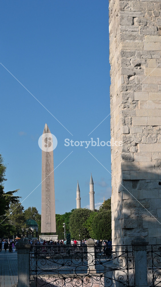Istanbul, turkey, august 1, 2025. Majestic obelisk of theodosius standing in sultanahmet square with the minarets of the famous hagia sophia mosque in the background