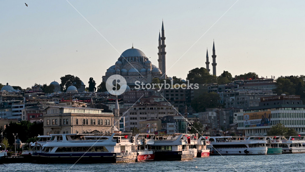 Istanbul,turkey,august 4, 2025. Famous historical cityscape of istanbul, turkey, featuring the suleymaniye mosque and the golden horn with ferries docked at the pier