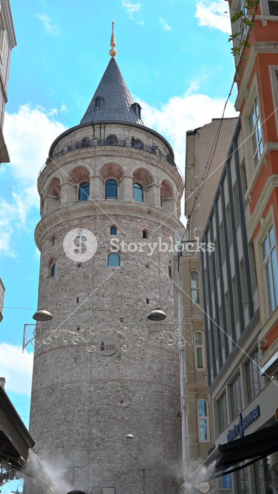Istanbul,turkey,august 13, 2025. Majestic view of the historic galata tower, a famous medieval stone landmark, rising against a blue sky with clouds