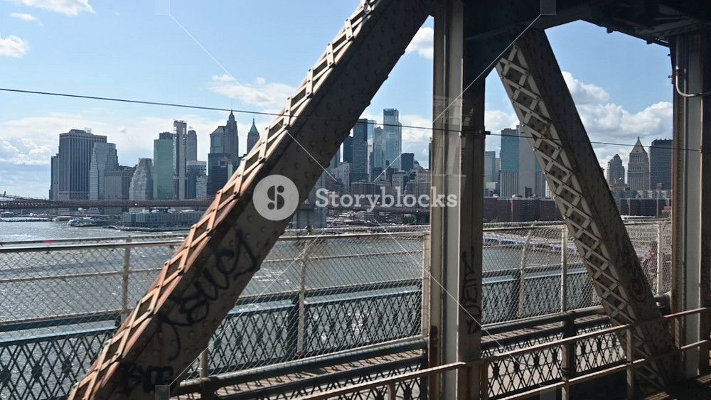 New York City, USA, August 21, 2024. Slow motion footage with a point of view from inside the subway as it crosses the Manhattan Bridge into Manhattan. An iconic cityscape.