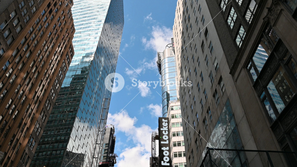 New York City, United States, August 21, 2024. Footage with iconic image of downtown Manhattan: mirrored skyscrapers overlooking the street and large advertising signs. Travel destinations.