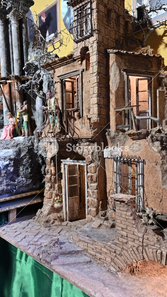 Naples, Italy, December 27, 2024. Vertical footage of Via S. Gregorio Armeno. Panning on a nativity scene for sale. A child's hand reaches out to touch it. Tourist attractions.