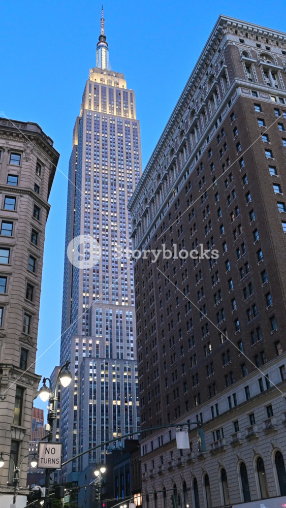 New York City, USA, August 20, 2024. Vertical shots of a city icon: the Empire State Building stands out in the cityscape. Blue hour. Travel destinations.