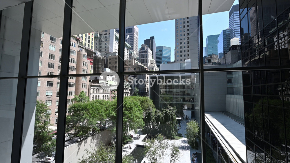 New York City, USA, August 20, 2024. Footage from a hall of the Museum of Modern Art looking out where people are taking a break during their tour. View from above. Beautiful summer day.