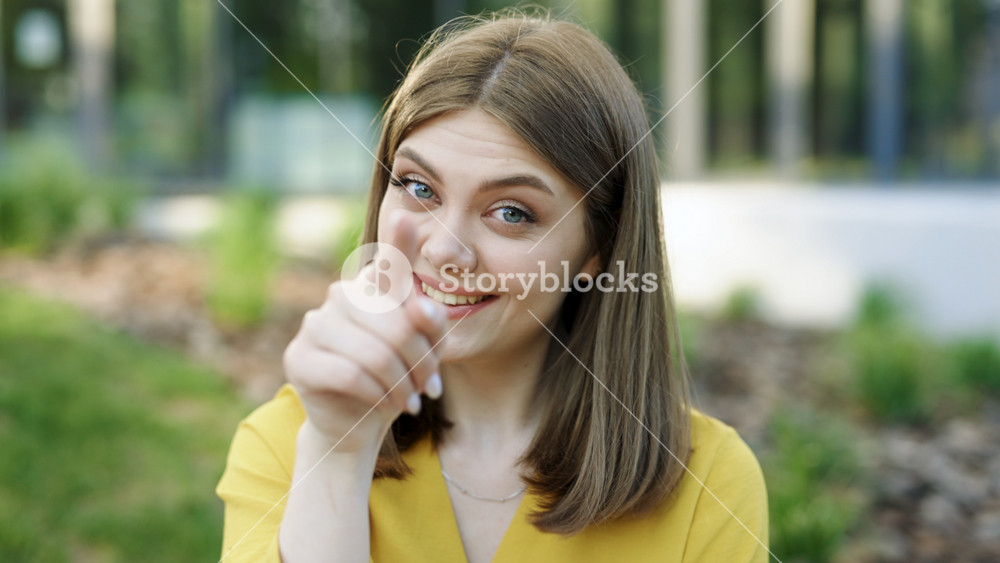 Hey you, come here. European ukraininan girl pointing index finger at camera inviting with hand gesture. Young ethnic happy woman calling to