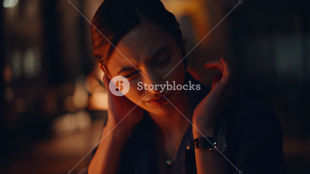 Overtime specialist massaging neck at dark office closeup. Portrait tensed businesswoman suffeering of muscle pain from late work