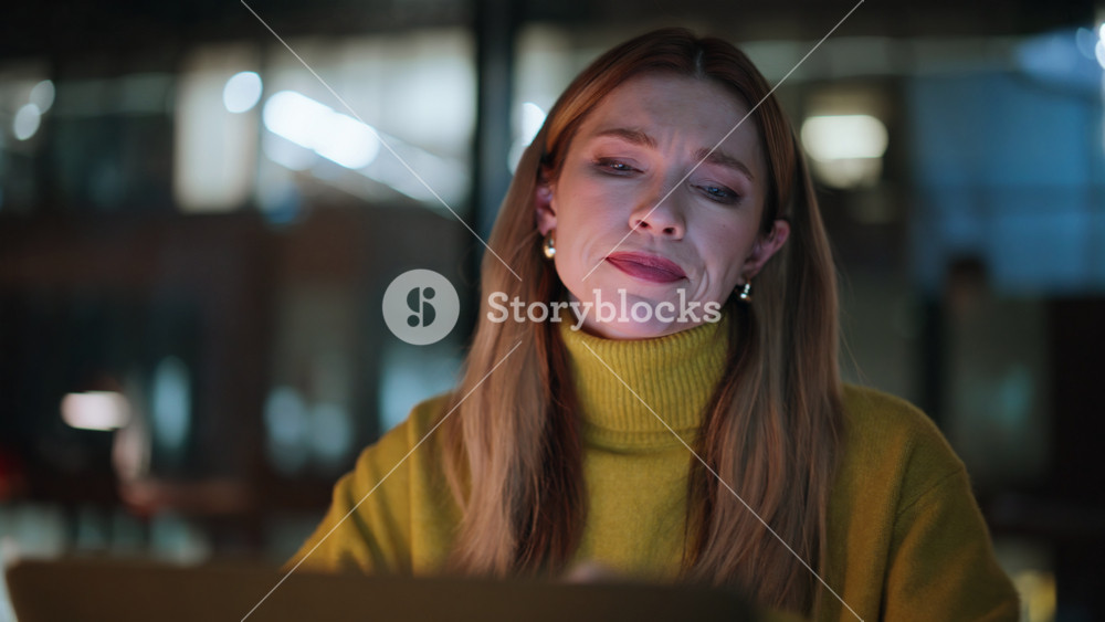 Stressed freelancer working late evening closeup. Frustrated woman reading bad news on laptop sitting night workspace. Unhappy businesswoman