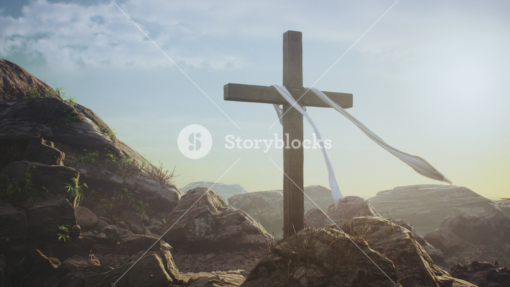 Zoom out view of wooden cross with fluttering cloth placed on rocks against blue sky on day of Jesus Christ resurrection on Golgotha in Jerusalem