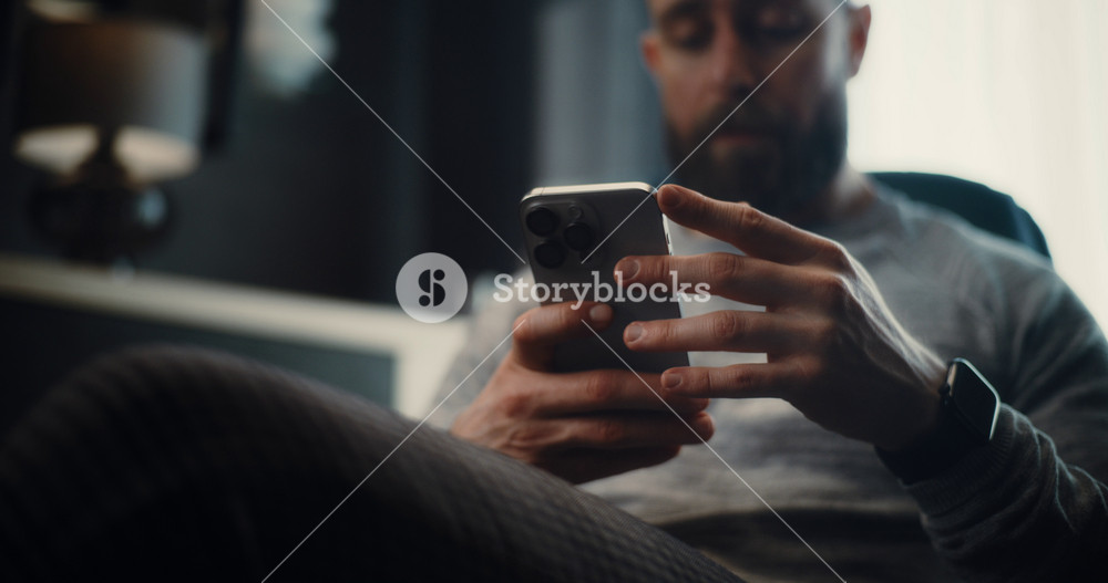 Close Up of Financial Expert Working on Smartphone, Monitoring Real-Time Stocks and Exchange Market Charts, Making Investments. Successful