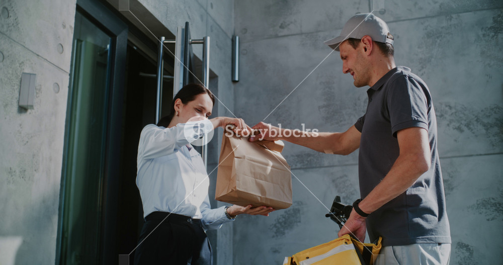 Delivery Man on E-Scooter Brining Brown Paper Bag with Online Shopping Order for Businesswoman Working in Office Building. Happy Woman