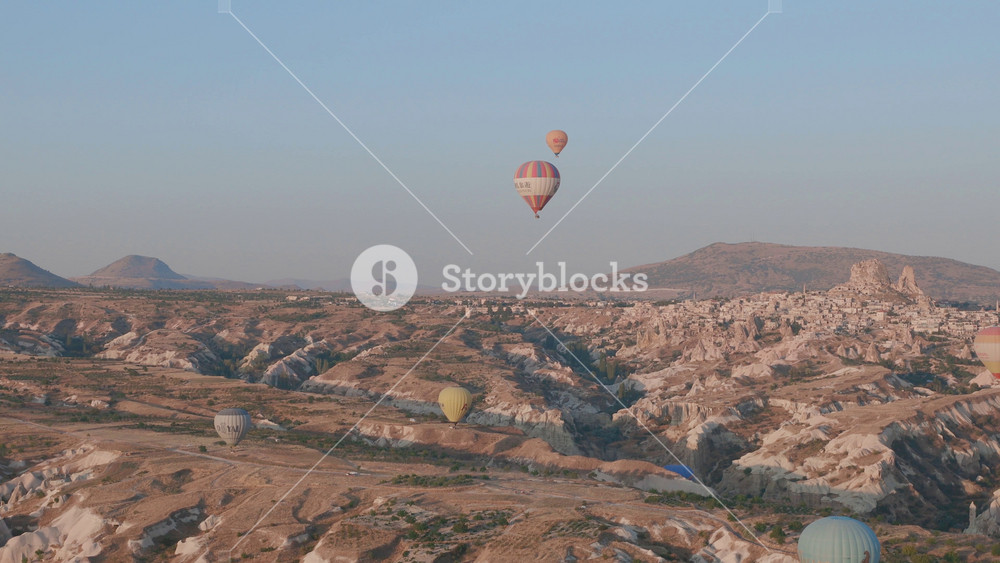 Aerial view from hot air balloon during Sunrise over the fairytale landscape hills of Kapadokya with morning light.