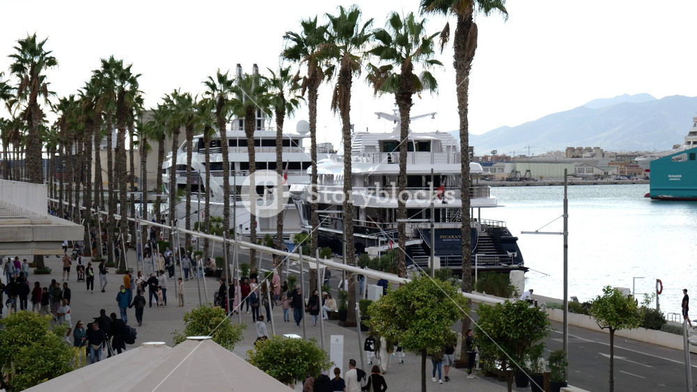 superyachts docked port malaga spain luxurious vessels along promenade vibrant attracts panning shot of scenic view travel experience