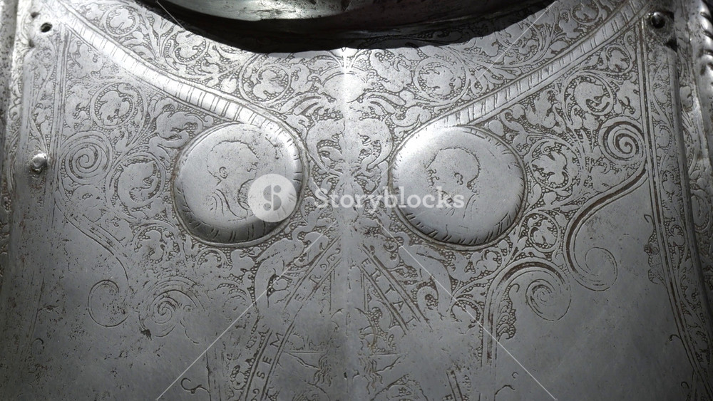 engraved breastplate detail palace armoury grand master's palace valletta twin portrait medallions scrollwork relief steel cuirass parade armor profile busts knights of malta armoury collection
