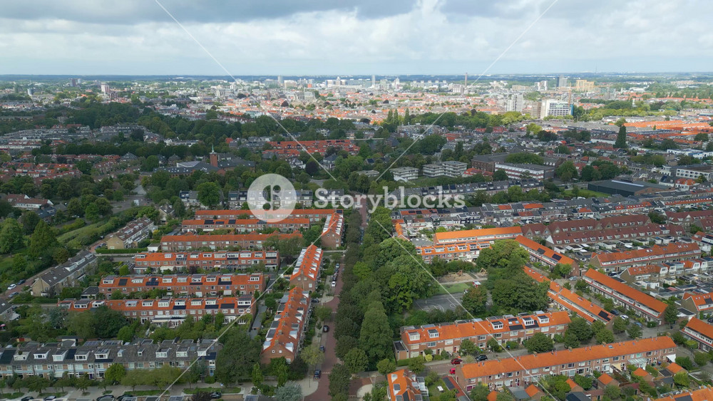 city leiden netherlands houses residential area community district shadow clouds over town side circling sideways aerial view of urban