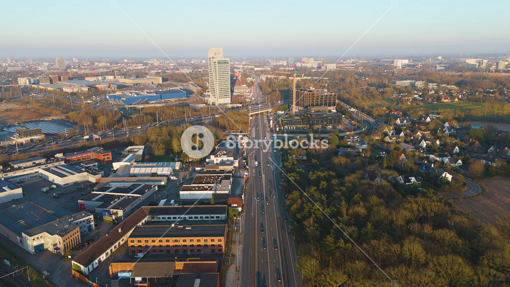 straight arterial road leads kbc tower highway ramps office blocks warehouses leafy neighborhoods fade inghent skyline belgium to city urban landscape
