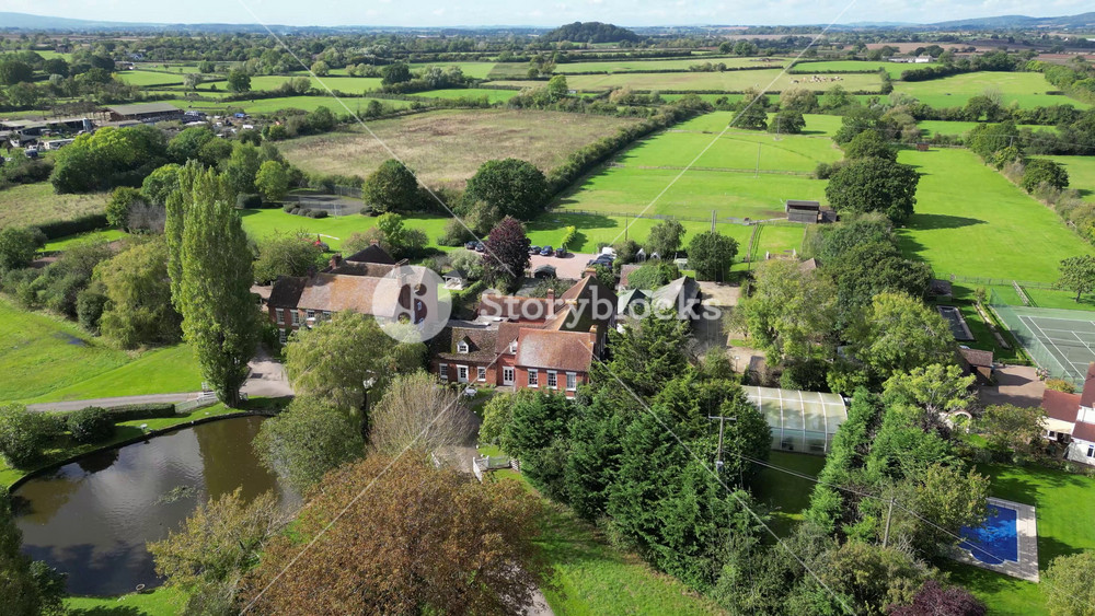 luxury property castle estate hotel basking sunshine england elegance real mansion highlighted against beautiful forward aerial shot drone uk scenic view investment unique
