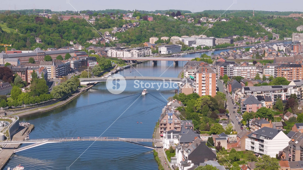 sombre river wallonia city banks along bridges traffic road revealing left pans aerial footage belgium panning scenic view observation riverbanks