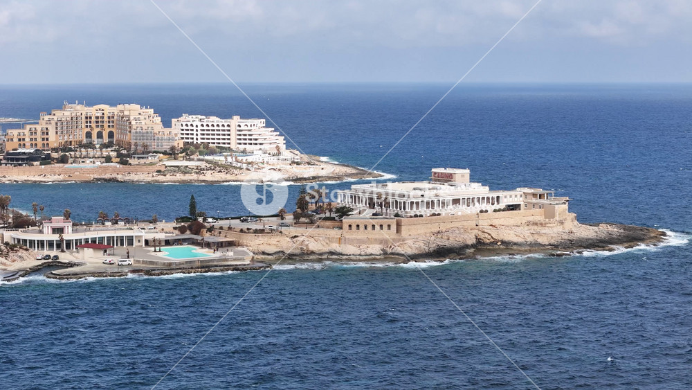 dragonara point casino complex st julian's aerial view rocky cliffs luxury resorts pool terrace malta Mediterranean lifestyle luxury real estate clear blue sky turquoise sea holiday resort development