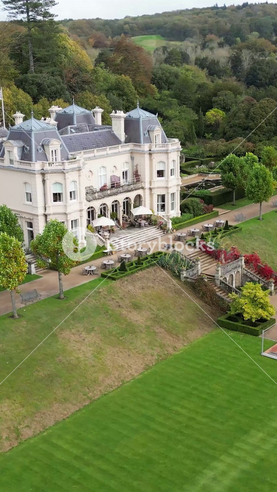 beaverbrook castle estate country house hotel resort england uk facade movement flying over gardens revealing area landscape forest trees autumn close up front circling aerial europe