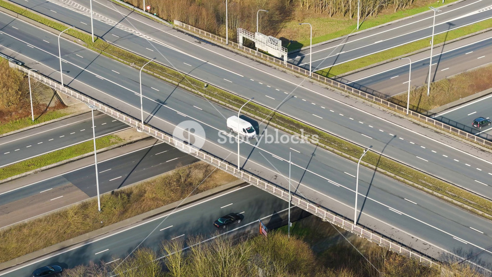 motorway bridge ghent light traffic crossing layered highway infrastructure green roadside landscape overhead near aerial drone view transport transportation vehicle travel