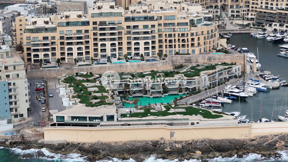 yacht marina st julian's aerial view luxury villa style residences infinity pools rooftop gardens malta Mediterranean lifestyle luxury real estate clear blue sky turquoise sea island living