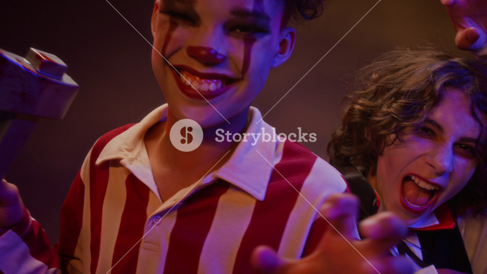 Portrait of multiethnic teenagers wearing Halloween costumes, posing and making scary faces at camera. Footage is perfect for Halloween holiday promotions and seasonal marketing campaigns