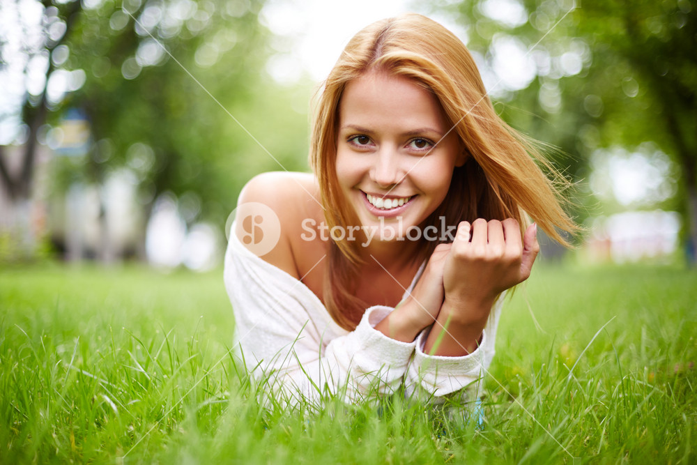 Happy Girl Lying In Grass And Looking At Camera With Smile Royalty-Free ...