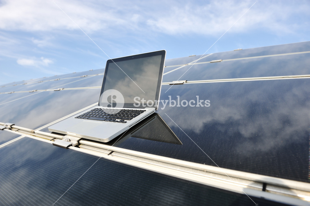 Laptop on photovoltaic solar panels against blue sky Royalty-Free Stock ...