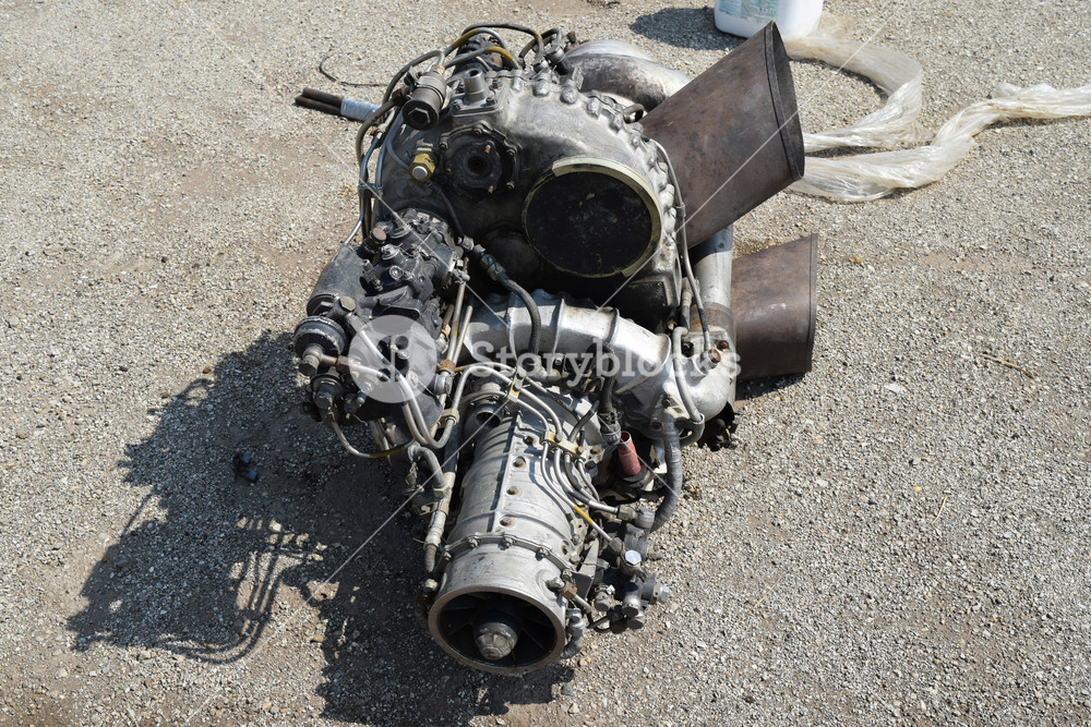 The helicopter engine which is pulled out outside. spare parts and ...