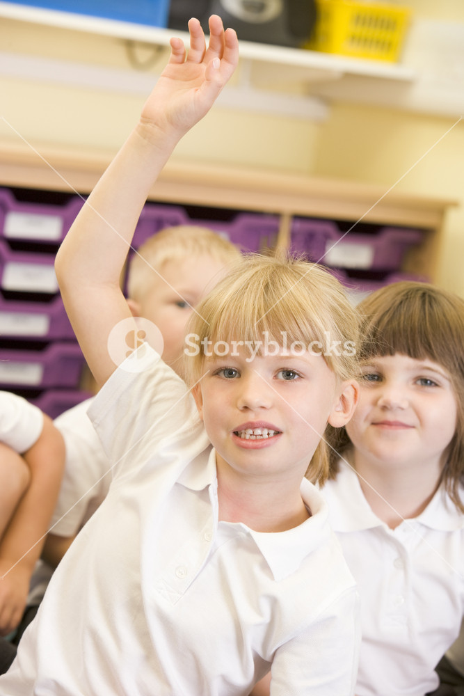 A schoolgirl raises her hand in a primary class Royalty-Free Stock ...