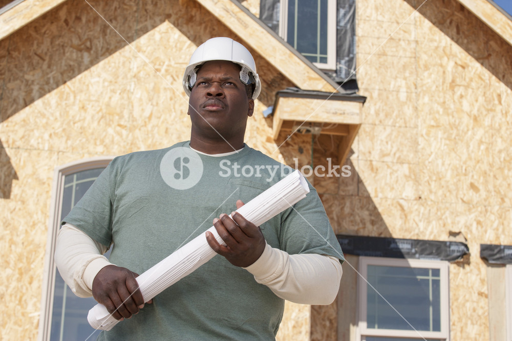Builder constructing a home Royalty-Free Stock Image - Storyblocks