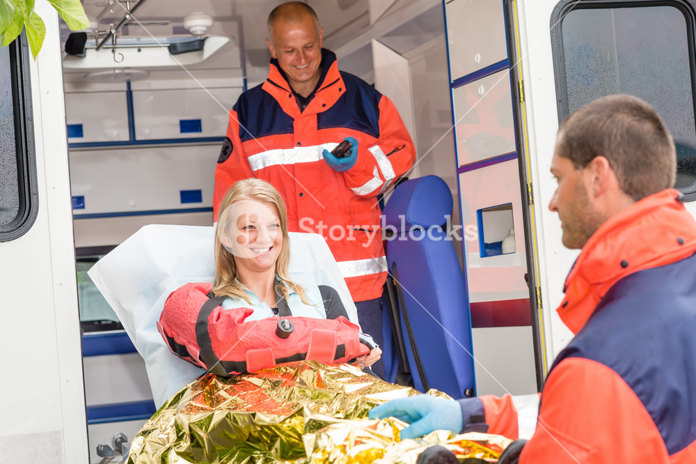 Woman with broken arm in ambulance paramedics accident helping victim ...